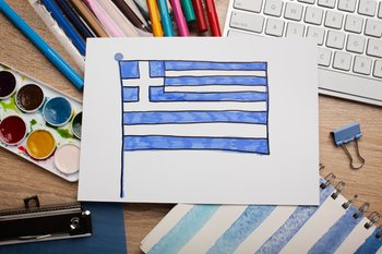 A child's drawing of the Greek flag against a blue sky, symbolizing the joy of Independence Day celebrations.