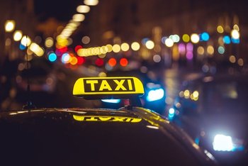 Yellow Uber Taxi driving through Athens streets 2026