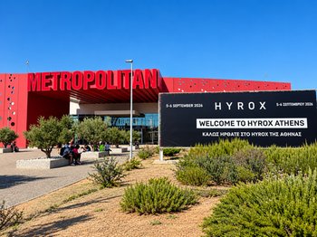 Exterior view of Metropolitan Expo, the venue for HYROX Athens 2026, featuring the large red 'METROPOLITAN' sign and a black banner welcoming visitors to the HYROX fitness race on September 5-6, 2026, in Athens, Greece.